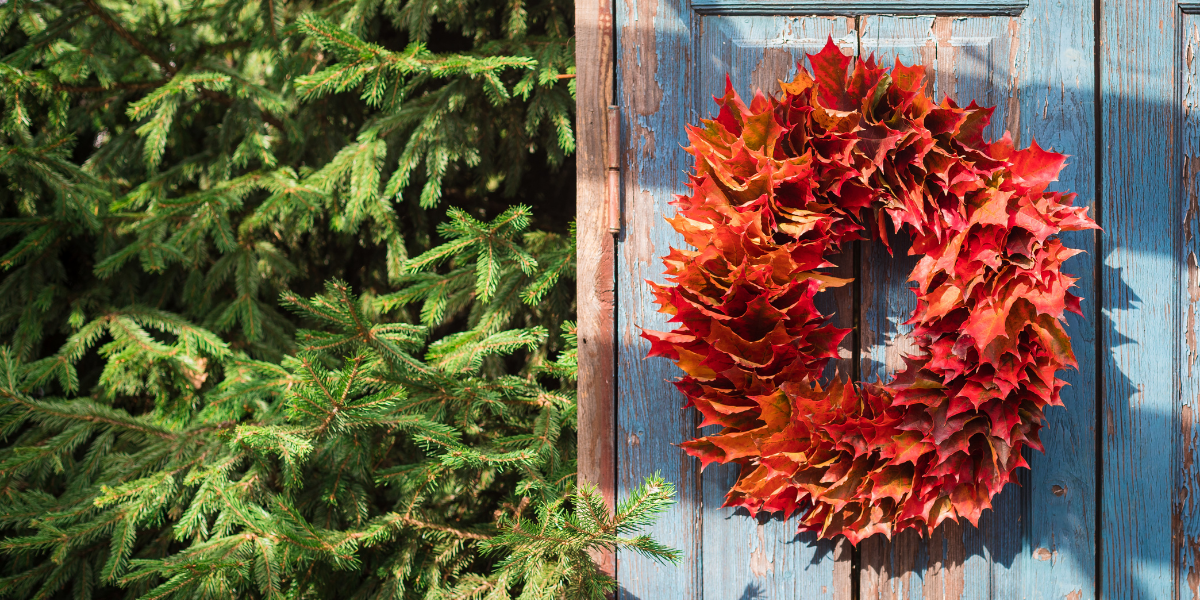 A door with a wreath made of autumn leaves